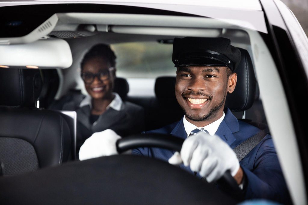 Businessperson working on laptop in a luxury car